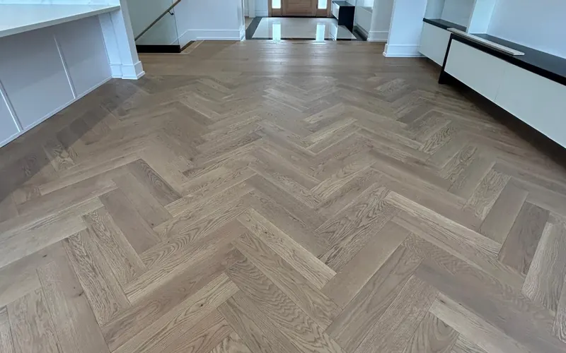 Engineered oak herringbone floor installed across an open living area in Toronto