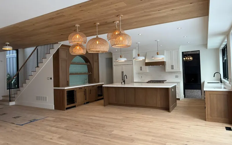 Finished hardwood floor and staircase in an open-plan Toronto kitchen renovation